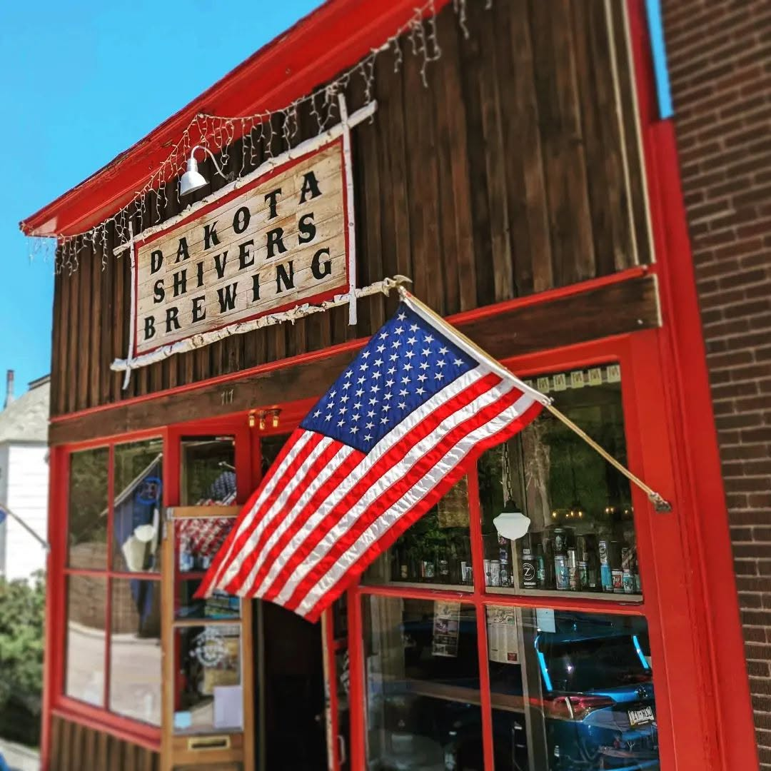 Dakota Shivers Brewing storefront with American flag outside